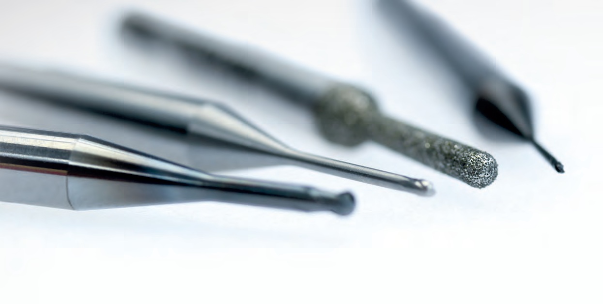 Close-up of precision-engineered dental milling tools including diamond-coated and carbide burs, used for accurate and durable CAD/CAM milling in dental laboratories.